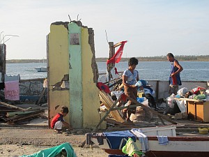 A family sifts through what is left of their home after super-typhoon Yoland hit Northern Cebu (Photo Credit: Moises Musico)